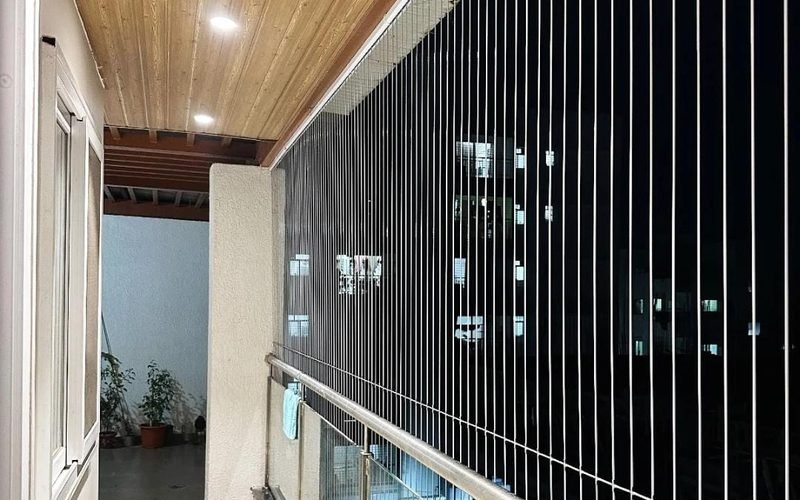 Invisible safety grill wires along an apartment balcony